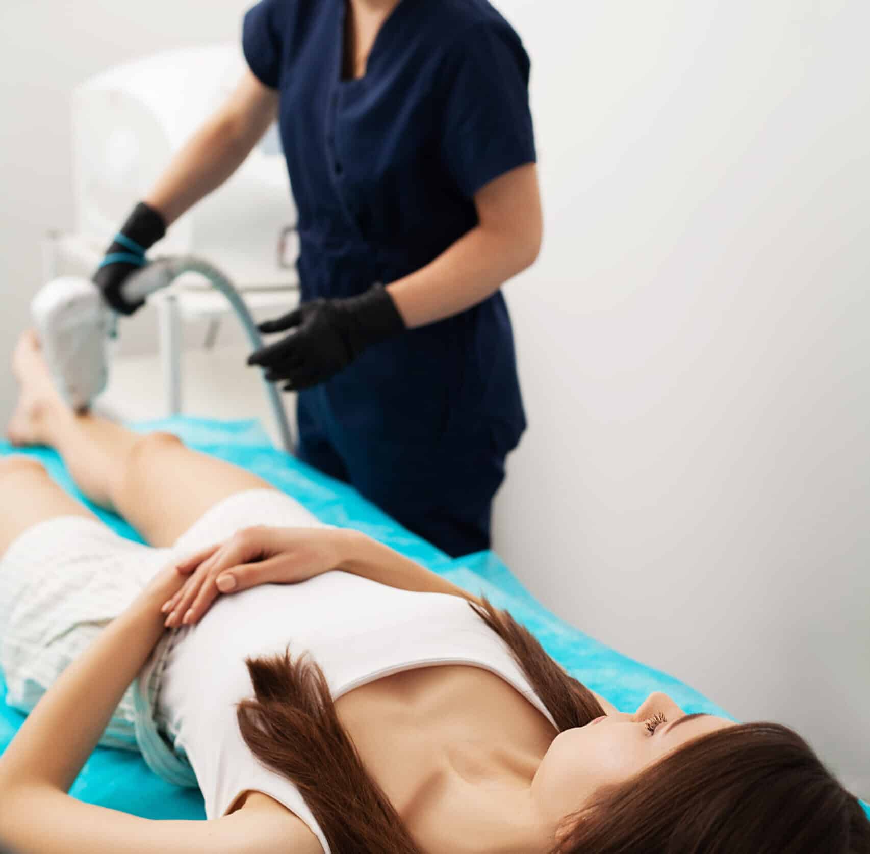 Woman getting laser treatment in a beauty salon.